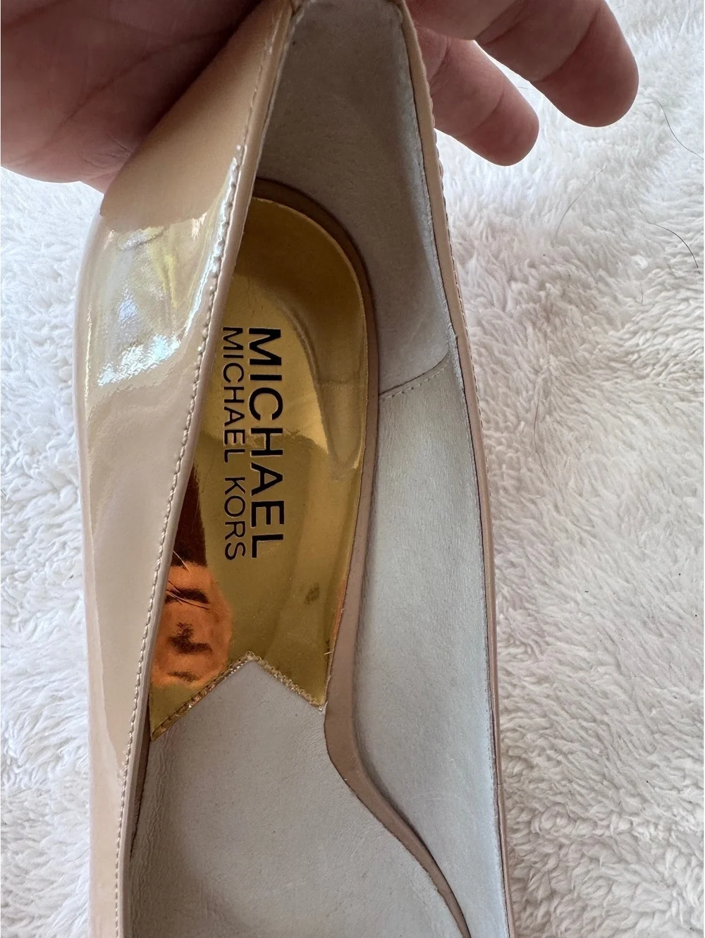 Michael Kors women’s patent leather peep-toe pumps in a classic nude/blush color